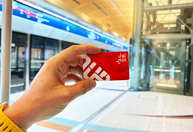 Tourists using a Dubai NOL card to travel between major attractions including Burj Khalifa and Dubai Marina