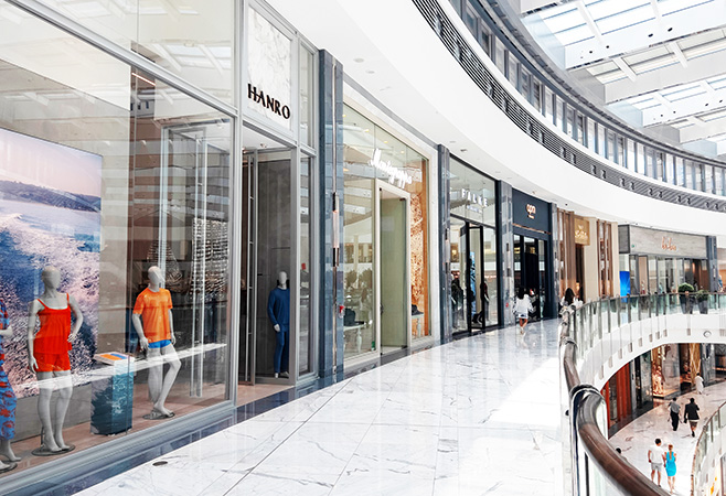 Shoppers exploring discounted luxury fashion brands at Dubai Outlet Mall in Dubai