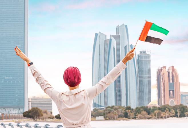 Citizen woman stands tall with the UAE flag
