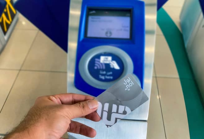 Tourist using a NOL card to travel on the Dubai Metro